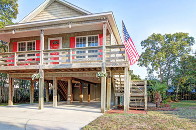Small coastal brown one-story vinyl gable roof idea in Other