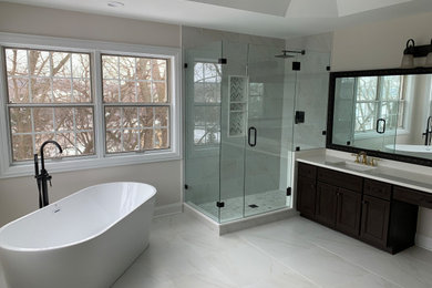 Inspiration for a large transitional master white tile and porcelain tile double-sink freestanding bathtub remodel in Chicago with recessed-panel cabinets, brown cabinets, quartz countertops, white countertops and a built-in vanity