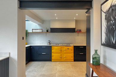 Example of a mid-sized trendy l-shaped porcelain tile, beige floor and vaulted ceiling eat-in kitchen design in Other with an undermount sink, shaker cabinets, blue cabinets, quartz countertops, white backsplash, no island and white countertops