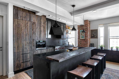 Kitchen - industrial kitchen idea in New York