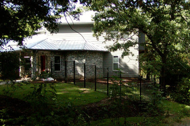 Mid-sized traditional one-storey grey house exterior in Dallas with mixed siding, a hip roof and a mixed roof.