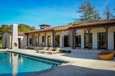Mid-sized mediterranean white one-story stucco exterior home idea in San Francisco with a tile roof