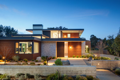 Large trendy two-story mixed siding exterior home photo in San Francisco with a mixed material roof and a gray roof