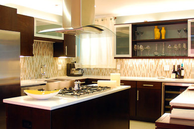 Large trendy u-shaped beige floor kitchen photo with a farmhouse sink, flat-panel cabinets, dark wood cabinets, quartzite countertops, beige backsplash, matchstick tile backsplash, stainless steel appliances and an island