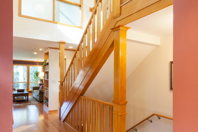 Photo of a mid-sized transitional foyer in Portland with medium hardwood floors and white walls.