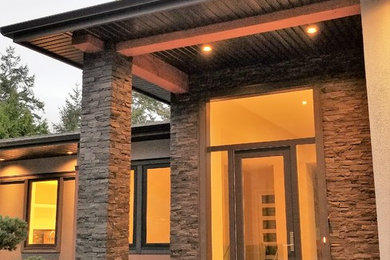 Inspiration for a mid-sized transitional multicolored two-story mixed siding house exterior remodel in Other with a hip roof and a shingle roof