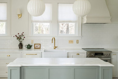Inspiration for a mid-sized cottage light wood floor enclosed kitchen remodel in Other with a farmhouse sink, shaker cabinets, green cabinets, marble countertops, white backsplash, ceramic backsplash, paneled appliances, an island and white countertops