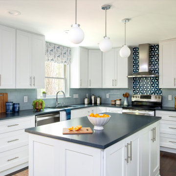 White and blue kitchen with island with white cabinets and soapstone quartz coun