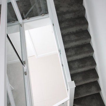 White staircase with clamped glass balustrade