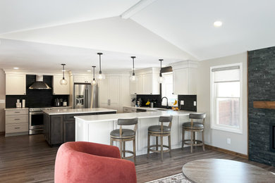 Huge transitional u-shaped vinyl floor, brown floor and vaulted ceiling kitchen photo in New York with an undermount sink, shaker cabinets, gray cabinets, quartz countertops, black backsplash, ceramic backsplash, stainless steel appliances, an island and white countertops