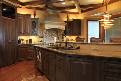 Enclosed kitchen - large transitional u-shaped dark wood floor enclosed kitchen idea in Wichita with a double-bowl sink, raised-panel cabinets, dark wood cabinets, gray backsplash, matchstick tile backsplash, stainless steel appliances, an island and granite countertops