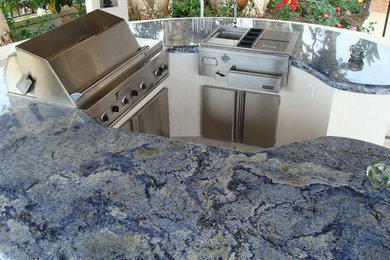 Large island style backyard patio kitchen photo in San Diego with a gazebo