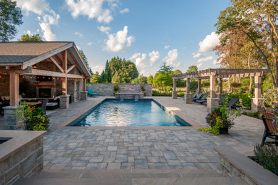 Huge arts and crafts backyard concrete paver and rectangular natural pool landscaping photo in Toronto