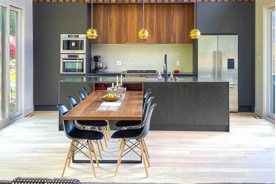 Example of a mid-sized minimalist light wood floor eat-in kitchen design in Toronto with flat-panel cabinets, dark wood cabinets, tile countertops, beige backsplash, an island and black countertops