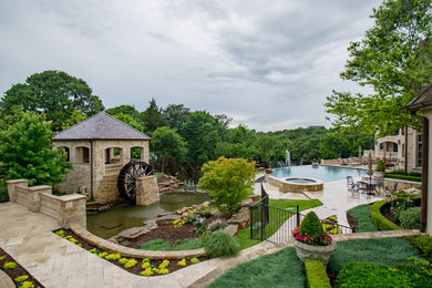 Pool fountain - huge transitional backyard stone and custom-shaped infinity pool fountain idea in Dallas