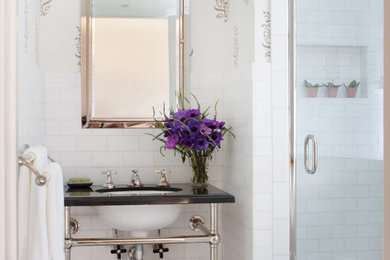 Mid-sized traditional 3/4 bathroom in Los Angeles with white tile, marble floors, an undermount sink, an alcove shower, a two-piece toilet, stone tile, multi-coloured walls, marble benchtops, multi-coloured floor and black benchtops.