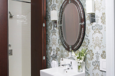 Inspiration for a small eclectic dark wood floor and brown floor bathroom remodel in New York with flat-panel cabinets, dark wood cabinets, a wall-mount toilet, multicolored walls and an integrated sink