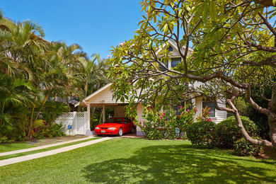 Island style white two-story wood gable roof photo in Hawaii