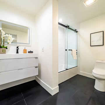 White and Charcoal Bathroom with Sliding Glass Shower Door