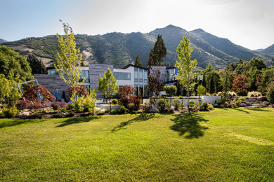 Inspiration for a huge contemporary backyard landscaping in Salt Lake City.