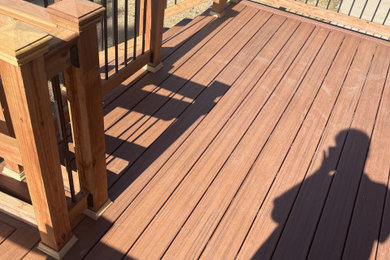 Example of a mid-sized minimalist courtyard ground level mixed material railing deck design in Denver with no cover