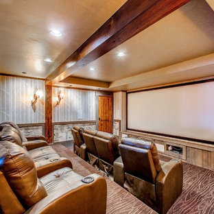 Mountain style enclosed carpeted home theater photo in Boise with multicolored walls and a projector screen