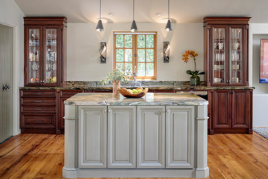 Inspiration for a mid-sized traditional single-wall open plan kitchen in San Francisco with an undermount sink, raised-panel cabinets, dark wood cabinets, quartz benchtops, multi-coloured splashback, stainless steel appliances, medium hardwood floors, with island, beige floor and multi-coloured benchtop.