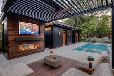 Mid-sized trendy backyard concrete and rectangular pool landscaping photo in Boston