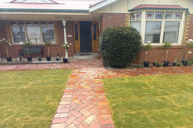 Design ideas for a large front yard full sun garden in Melbourne.