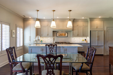 Inspiration for a mid-sized timeless single-wall dark wood floor and brown floor eat-in kitchen remodel in St Louis with an undermount sink, shaker cabinets, gray cabinets, quartz countertops, gray backsplash, ceramic backsplash, an island and gray countertops