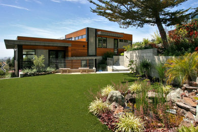Inspiration for a large modern backyard full sun xeriscape in San Francisco with a water feature and natural stone pavers.