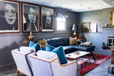 Inspiration for an eclectic family room in Kansas City with grey walls, porcelain floors, a standard fireplace, a brick fireplace surround and grey floor.