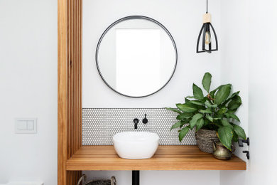 Inspiration for a contemporary bathroom in Sydney with white tile, mosaic tile, white walls, wood benchtops, grey floor, brown benchtops and a single vanity.