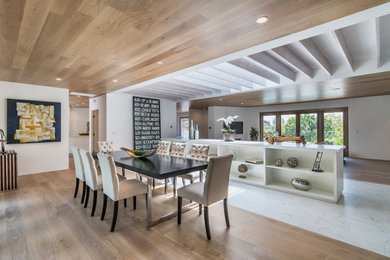 Inspiration for a mid-sized 1950s light wood floor and brown floor enclosed dining room remodel in Los Angeles with white walls
