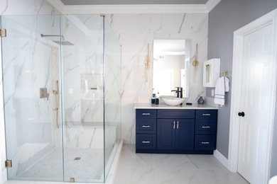 Example of a large minimalist master beige tile and porcelain tile porcelain tile, beige floor and double-sink bathroom design in Atlanta with shaker cabinets, blue cabinets, gray walls, a vessel sink, quartz countertops, a hinged shower door, beige countertops, a niche and a floating vanity