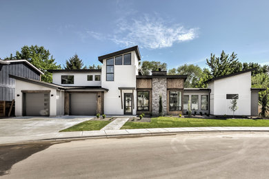 Example of a large trendy multicolored one-story mixed siding house exterior design in Boise with a shed roof and a shingle roof