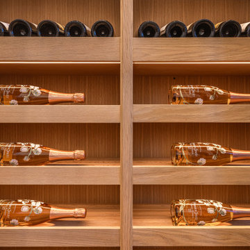 Luxury Modern Wine Wall Display with White Oak Cabinetry and Integrated LEDs