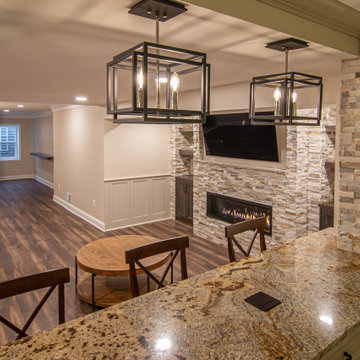 Basement Showing Warm Colors, Straight Lined Cabinets and Stacked Stone