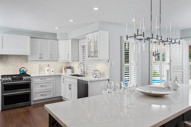 Eat-in kitchen - mid-sized contemporary u-shaped eat-in kitchen idea in Toronto with shaker cabinets, white cabinets, quartz countertops, an island and white countertops