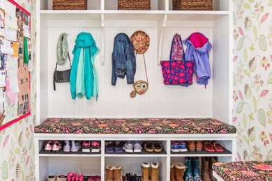 Inspiration for a transitional dark wood floor, brown floor and wallpaper mudroom remodel in Milwaukee with multicolored walls