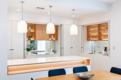 Inspiration for a contemporary kitchen in Adelaide with an integrated sink, white cabinets, glass sheet splashback and with island.