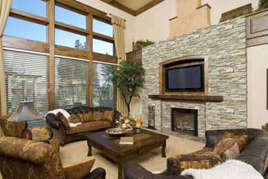 Design ideas for a mid-sized country enclosed family room in Dallas with beige walls, carpet, a standard fireplace, a stone fireplace surround and a built-in media wall.