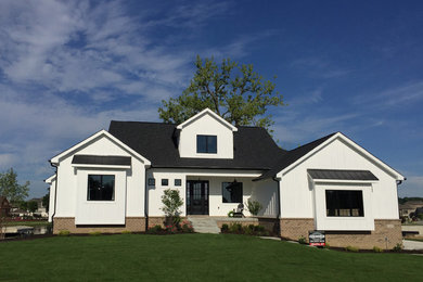 Mid-sized country one-storey white house exterior in Indianapolis with concrete fiberboard siding and a shingle roof.