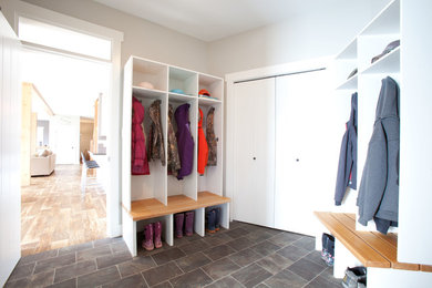 Mid-sized elegant slate floor entryway photo in Vancouver with gray walls and a light wood front door