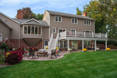 Large elegant backyard deck photo in Boston with a fire pit and a roof extension
