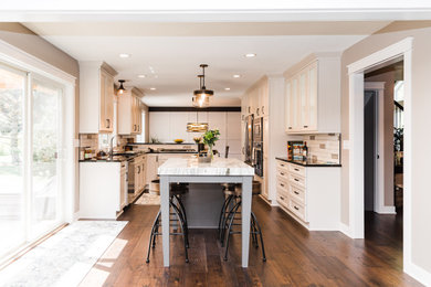 Inspiration for a transitional galley brown floor eat-in kitchen remodel in Minneapolis with flat-panel cabinets, white cabinets and an island