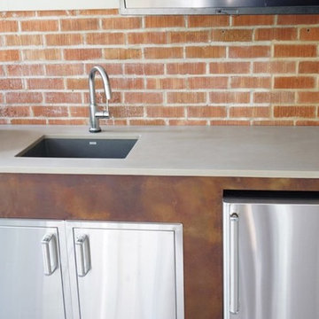 Concrete outdoor kitchen counters on rust patina cabinets