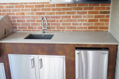 Large trendy backyard concrete patio kitchen photo in Denver with a roof extension