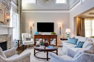 Large elegant loft-style dark wood floor living room photo in New York with a music area, gray walls, a standard fireplace, a stone fireplace and a wall-mounted tv
