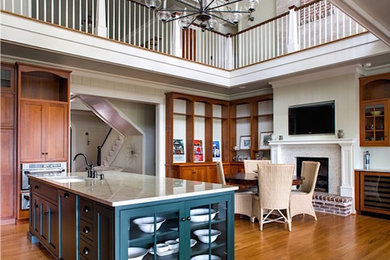 Example of a mid-sized ornate l-shaped light wood floor and brown floor eat-in kitchen design in Atlanta with an undermount sink, shaker cabinets, medium tone wood cabinets, quartzite countertops, stainless steel appliances and an island